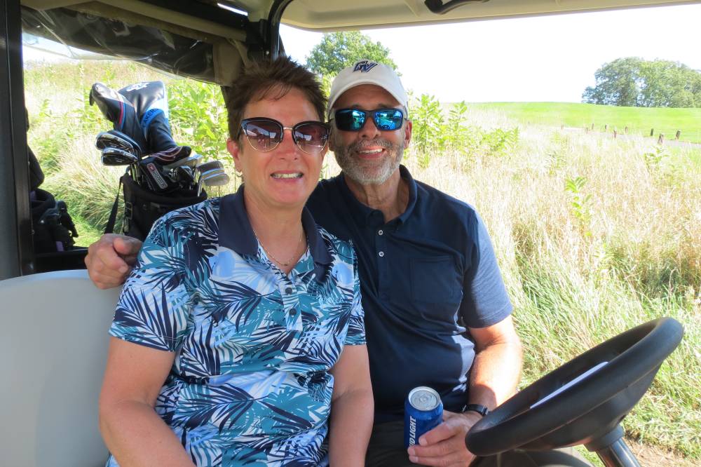 Man and woman in golf cart